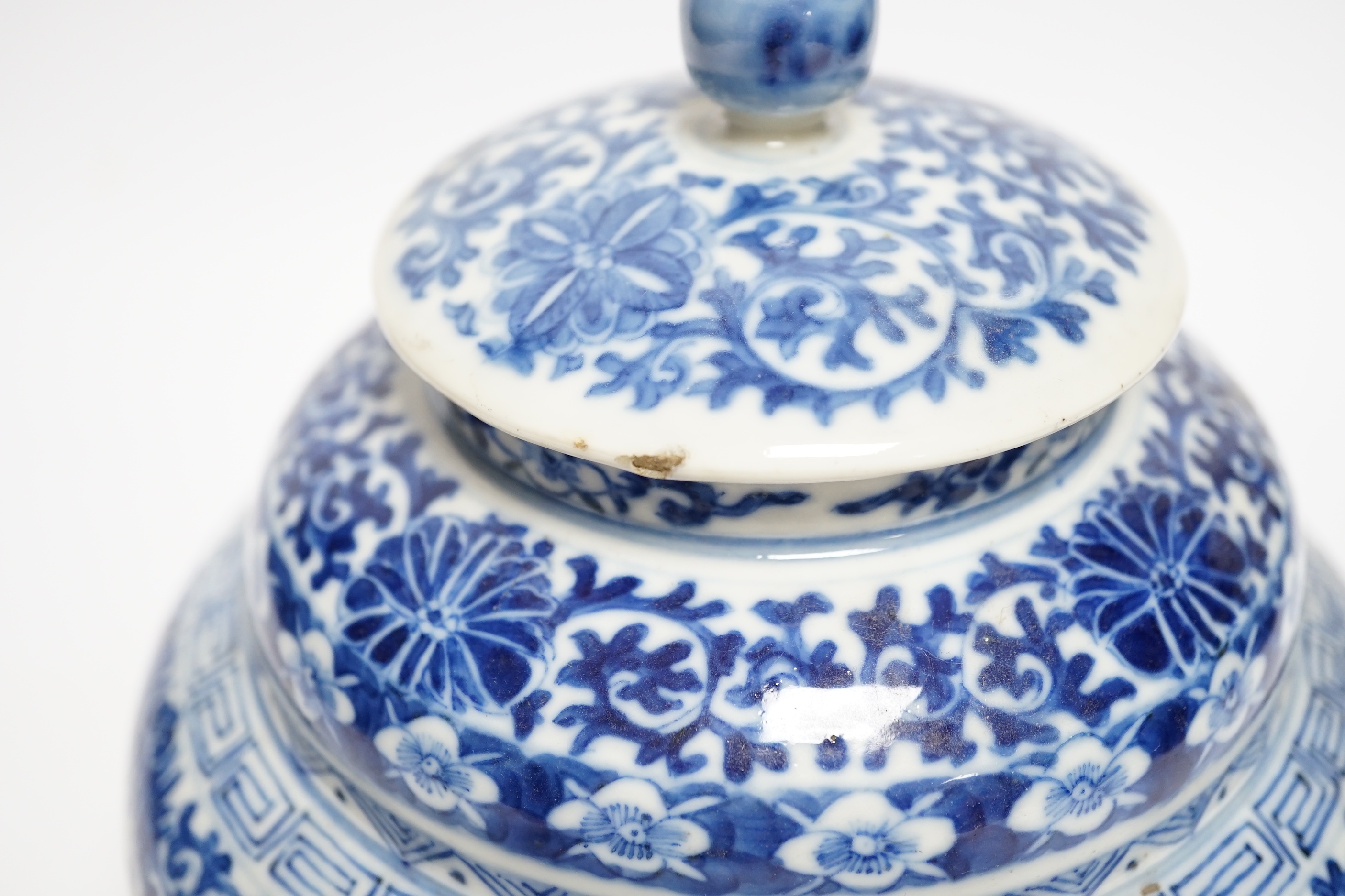A late 19th century Chinese blue and white floral jar and cover, seal mark, 17cm high
